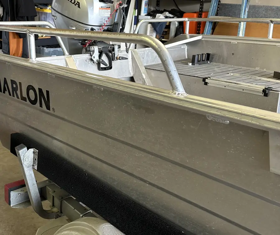 Aluminum boat with custom grab rails Neal welded along the sides
