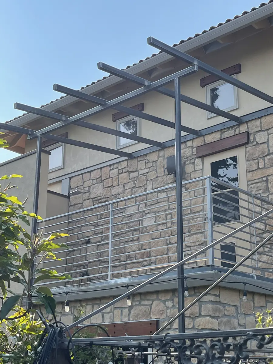 Finished steel trellis over a deck