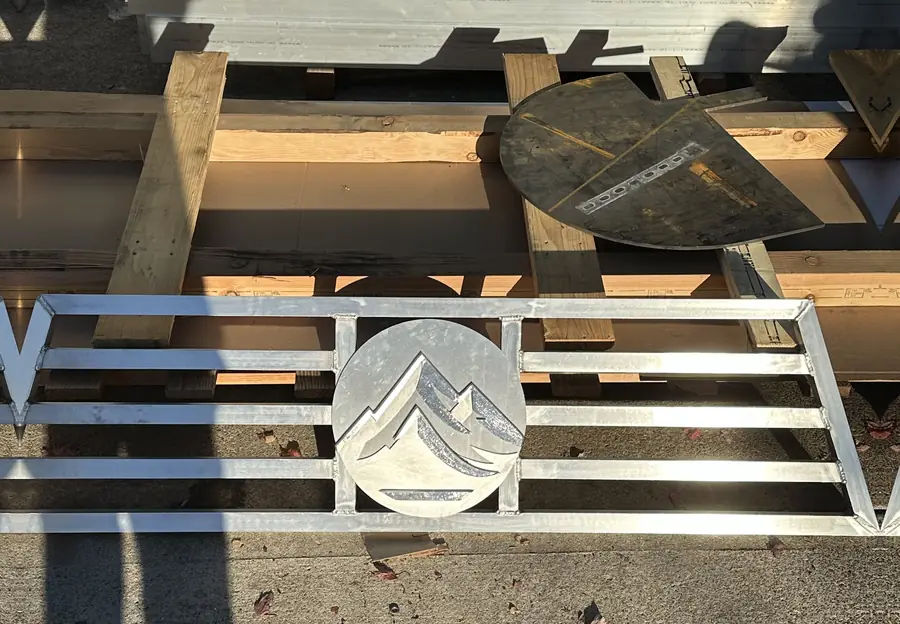 Aluminum headache rack panel with a cut logo, on the shop floor before install