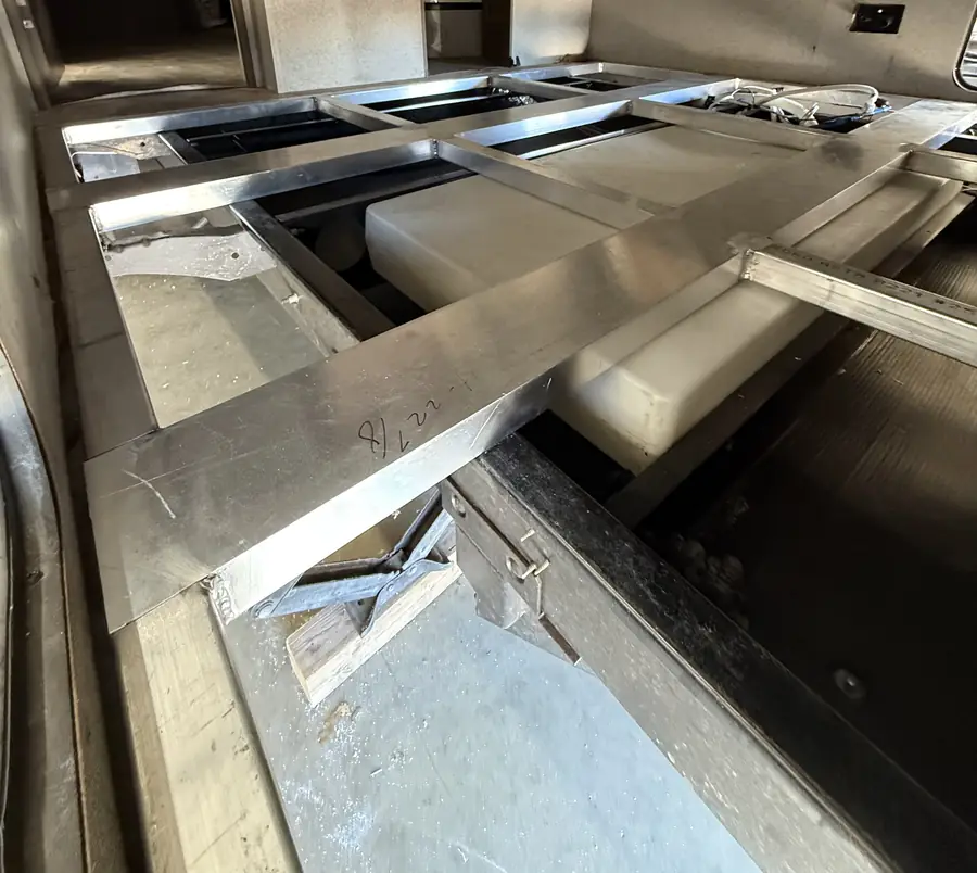 Aluminum tube floor frame Neal rebuilt and welded in place inside an RV