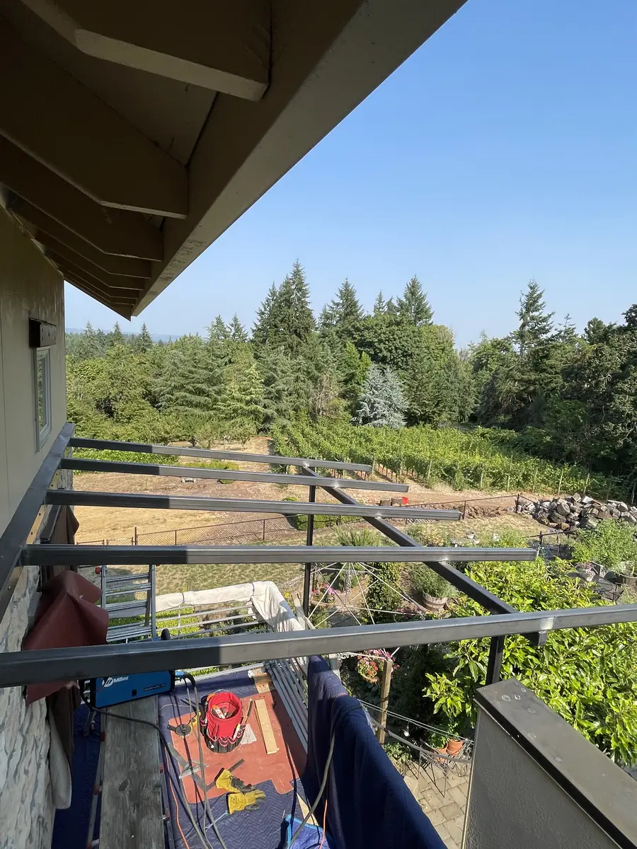 Steel trellis frame going up on a deck above a vineyard