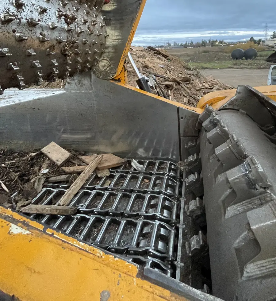 Toothed rotor inside a wood grinder at a recycling yard
